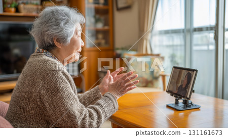Elderly woman having a daytime video call at home 131161673
