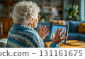 An elderly woman making an online call in the living room at home during the day 131161675