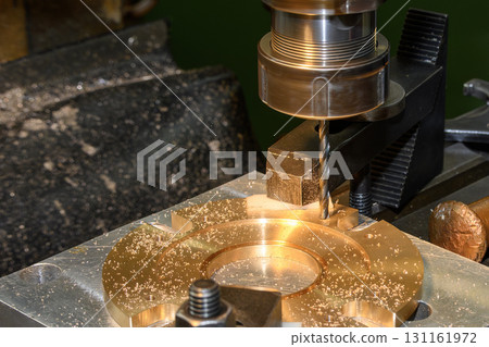 The hole drilling process the brass material parts on NC milling machine by drill tools. 131161972