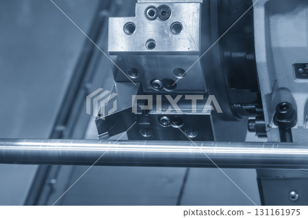The CNC lathe machine forming cutting the metal shaft parts in the light blue scene. The CNC lathe machine forming cutting the metal shaft parts in the light blue scene. 131161975