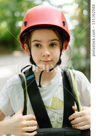 Portrait of girl in climbing harness and helmet 131162088