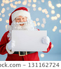 Santa Claus holding blank sign with festive lights 131162724