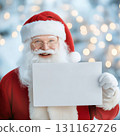 Santa Claus holding blank sign with cheerful smile 131162726