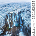 Aerial drone view of amazing waterfall and snowy forest in winter 131162925