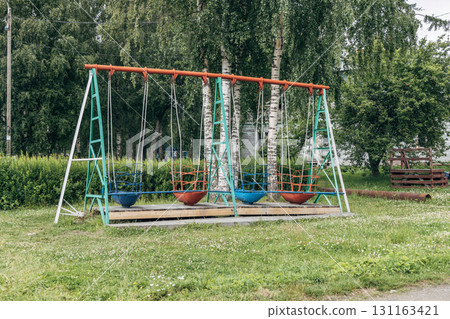 old swings on a playground in a park 131163421