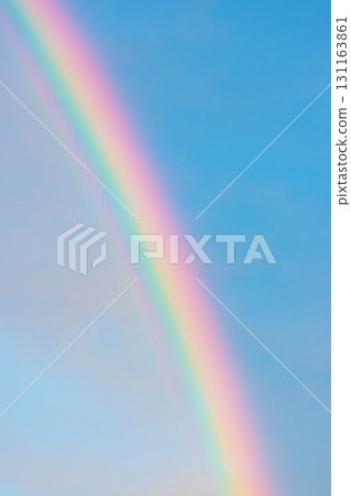 Rainbow in blue with clouds sky 131163861