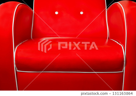 Red armchair isolated on black background 131163864