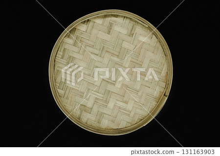 Round bamboo plate isolated on black background Round bamboo plate isolated on black background 131163903