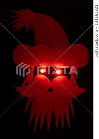 Santa Claus head made from paper with red light eyes 131163921