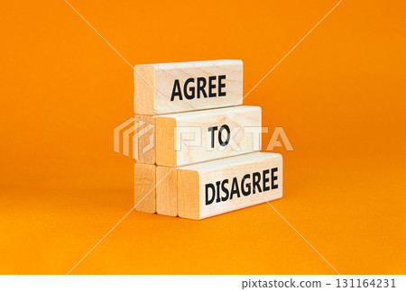 Agree to disagree symbol. Concept words Agree to disagree on beautiful wooden block. Beautiful orange table orange background. Business and agree to disagree concept. Copy space. Agree to disagree symbol. Concept words Agree to disagree on beautiful wooden block. Beautiful orange table orange background. Business and agree to disagree concept. Copy space. 131164231