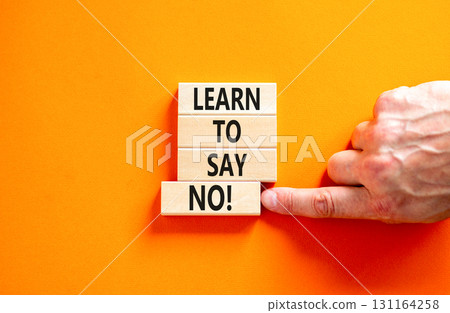 Learn to say no symbol. Concept words phrase Learn to say no on beautiful wooden blocks. Beautiful orange paper background. Businessman's hand Business psychological Learn to say no concept Copy space 131164258