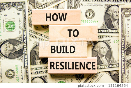 How to build resilience symbol. Concept words How to build resilience on beautiful wooden blocks. Beautiful background from dollar bills. Business and how to build resilience concept. Copy space. 131164264