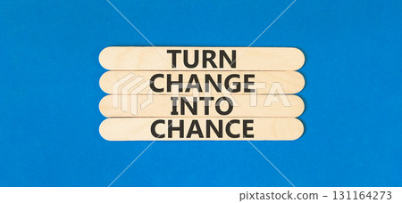 Turn change into chance symbol. Concept words phrase Turn change into chance on beautiful wooden stick. Beautiful blue paper background. Business Turn change into chance concept. Copy space. 131164273
