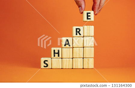 Share symbol. Concept word Share on beautiful wooden blocks. Beautiful orange table orange background. Businessman hand. Business lifestyle share concept. Copy space. Share symbol. Concept word Share on beautiful wooden blocks. Beautiful orange table orange background. Businessman hand. Business lifestyle share concept. Copy space. 131164300