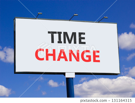 Time change symbol. Concept word Time change on beautiful white billboard. Beautiful blue sky and clouds background. Business time change concept. Copy space. Time change symbol. Concept word Time change on beautiful white billboard. Beautiful blue sky and clouds background. Business time change concept. Copy space. 131164315