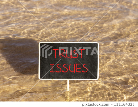 Trust issues symbol. Concept word Trust issues on beautiful black blackboard. Beautiful Red sea water background. Black blackboard. Business trust issues concept. Copy space. Trust issues symbol. Concept word Trust issues on beautiful black blackboard. Beautiful Red sea water background. Black blackboard. Business trust issues concept. Copy space. 131164325