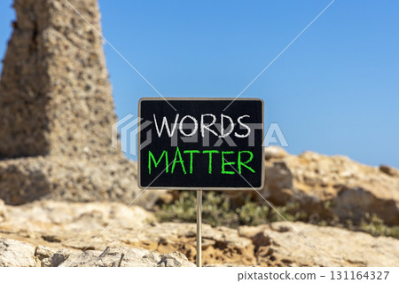 Words matter symbol. Concept word Words matter on beautiful black blackboard. Beautiful stone and blue sky background. Black blackboard. Business words matter concept. Copy space. Words matter symbol. Concept word Words matter on beautiful black blackboard. Beautiful stone and blue sky background. Black blackboard. Business words matter concept. Copy space. 131164327