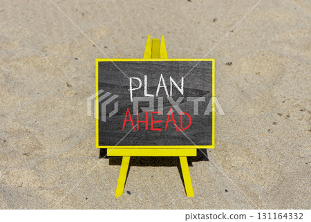 Plan ahead symbol. Concept word Plan ahead on beautiful black blackboard. Beautiful sand beach background. Black blackboard. Business plan ahead concept. Copy space. Plan ahead symbol. Concept word Plan ahead on beautiful black blackboard. Beautiful sand beach background. Black blackboard. Business plan ahead concept. Copy space. 131164332