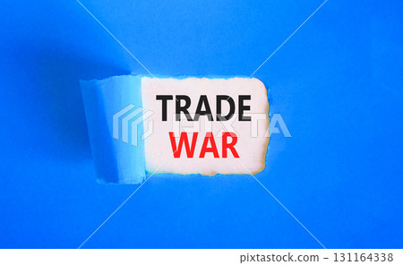 Trade war symbol. Concept word Trade war on beautiful white paper. Beautiful blue paper background. Business trade war concept. Copy space. Trade war symbol. Concept word Trade war on beautiful white paper. Beautiful blue paper background. Business trade war concept. Copy space. 131164338
