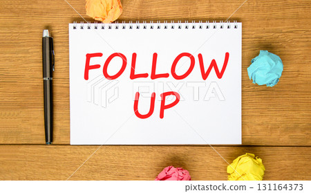 Follow up symbol. Concept word Follow up on beautiful white note. Black pen, colored paper. Beautiful wooden background. Business follow up concept. Copy space. Follow up symbol. Concept word Follow up on beautiful white note. Black pen, colored paper. Beautiful wooden background. Business follow up concept. Copy space. 131164373