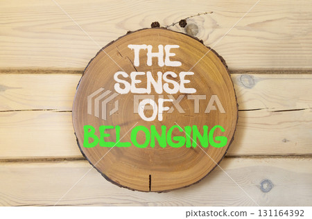 The sense of belonging symbol. Concept words The sense of belonging on beautiful wooden circle. Beautiful wooden wall background. Business and the sense of belonging concept. Copy space. 131164392