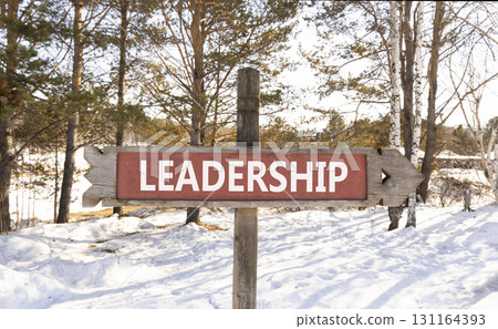 Leadership symbol. Concept word Leadership on beautiful wooden road sign. Beautiful winter forest background. Business leadership concept. Copy space. Leadership symbol. Concept word Leadership on beautiful wooden road sign. Beautiful winter forest background. Business leadership concept. Copy space. 131164393