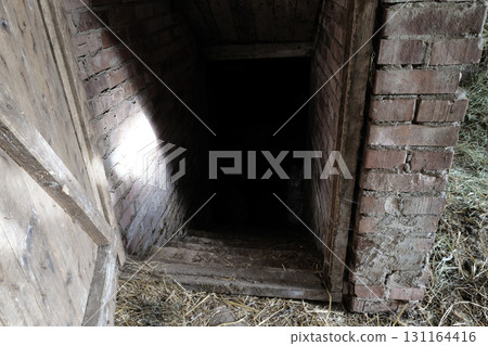 Spooky and Scary Dark Entrance to Food Basement of Barn in Countryside 131164416