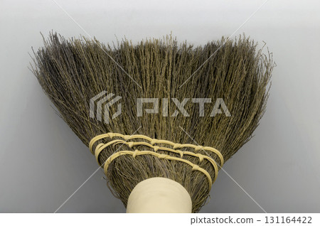 Straw broom on grey background 131164422