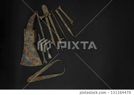 Very Old and Rusty Tools on Black Background with Free Space Very Old and Rusty Tools on Black Background with Free Space 131164479