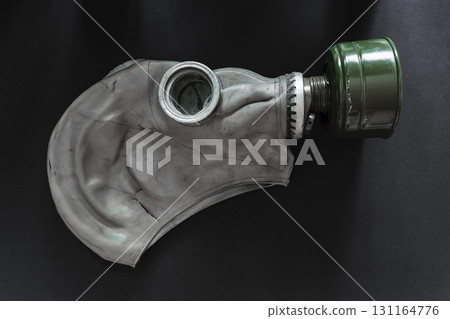 Very Old Gas Mask on Black Background Surface Very Old Gas Mask on Black Background Surface 131164776