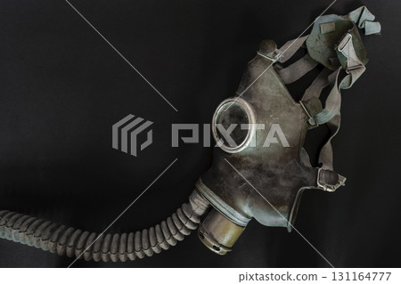 Very Old Gas Mask on Black Background Surface 131164777