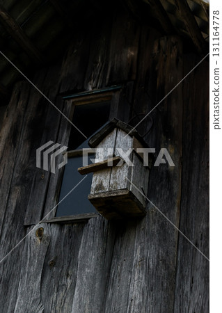 Very Old Gray Nesting Box Hanging on the Wooden Gray Barn Wall Very Old Gray Nesting Box Hanging on the Wooden Gray Barn Wall 131164778