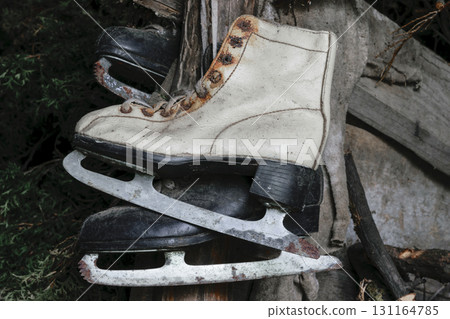 Very Old White and Black Rusty and Dirty Ice Skates Hanging in Warehouse Very Old White and Black Rusty and Dirty Ice Skates Hanging in Warehouse 131164785