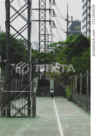 Woman walking in empty path in Thailand Woman walking in empty path in Thailand 131164826