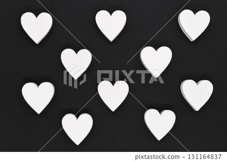 White wooden hearts on black background 131164837