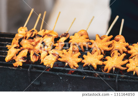 Yellow squids preparing on grill in Thailand market 131164850