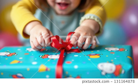Child's Hands Unwrapping a Colorful Birthday Gift with Confetti Background Child's Hands Unwrapping a Colorful Birthday Gift with Confetti Background 131164878
