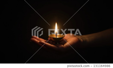 Minimalist Brass Diya Lighting Against Pure Black Background Symbolis. Dashahra, India. Minimalist Brass Diya Lighting Against Pure Black Background Symbolis. Dashahra, India. 131164986