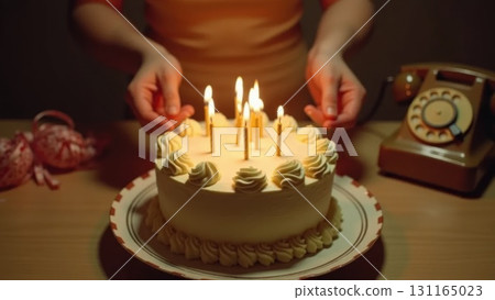 Vintage 1970s Birthday Celebration Hands Blowing Out Candles on Cake 131165023