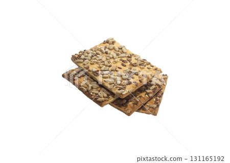 Stacked flax and sunflower seed cookies isolated on a white background are perfect for snack branding, packaging visuals, or baked goods advertising. Stacked flax and sunflower seed cookies isolated on a white background are perfect for snack branding, packaging visuals, or baked goods advertising. 131165192