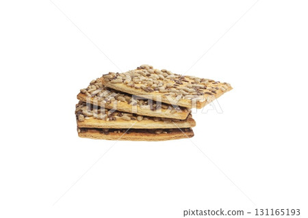 Stacked flax and sunflower seed cookies isolated on a white background are perfect for snack branding, packaging visuals, or baked goods advertising. 131165193