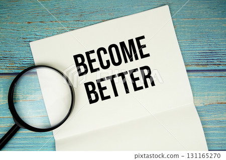 Become Better text written on notepad with magnifying glass flat lay on wooden background Become Better text written on notepad with magnifying glass flat lay on wooden background 131165270