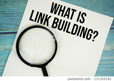 What is Link Building? text written on notepad with magnifying glass flat lay on wooden background 131165282
