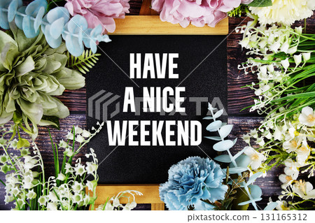 Have a Nice Weekend text with flowers bouquet decoration on wooden background 131165312