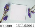 Empty white blank greeting or invitation card with  violet flower on blue background. 131168001