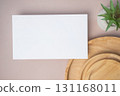 Empty white blank greeting or invitation card, cactus, wooden plate on beige background. Mock up presentation. 131168011