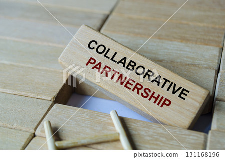 Collaborative Partnership text written on wooden blocks arranged on a ladder emphasizing teamwork and shared effort. 131168196