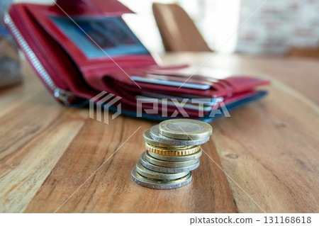 Coins stack on the wood table near the leather partmone. Wallet with european money for commerce business concept. 131168618