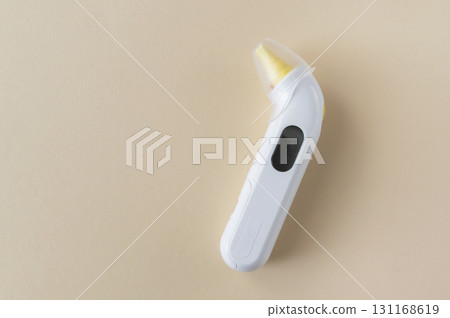 White digital thermometer for temperature measurement on yellow background. White digital thermometer for temperature measurement on yellow background. 131168619