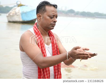 Hindu Devotee Performing Mahalaya Tarpan in Kolkata Babu Ghat Hindu Devotee Performing Mahalaya Tarpan in Kolkata Babu Ghat 131168626